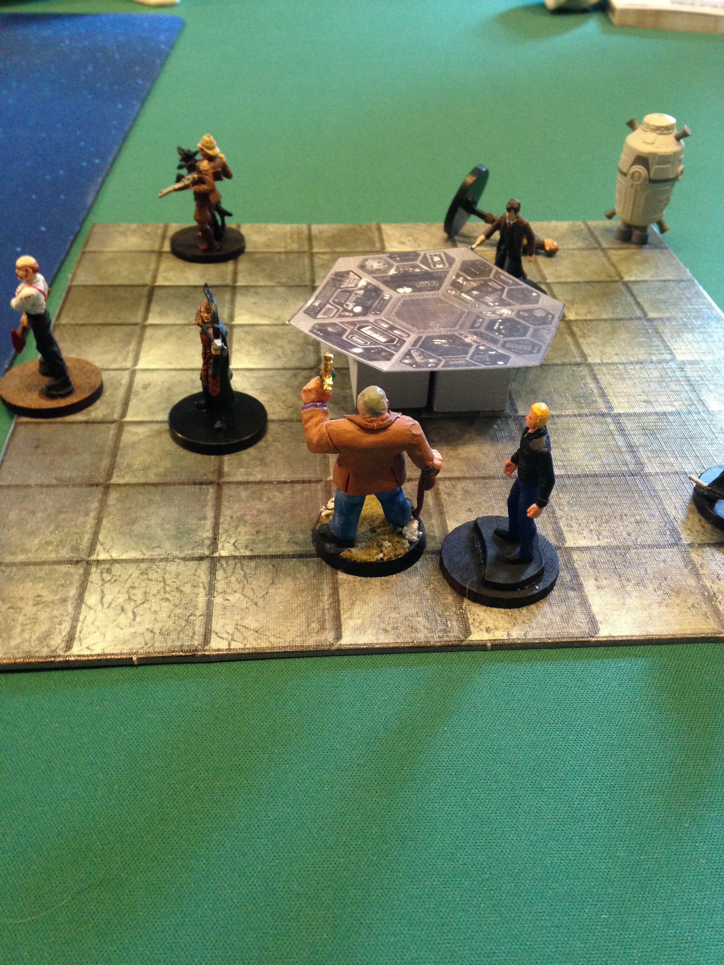 The heroes gather around the TARDIS's control panel as the Doctor takes the controls.